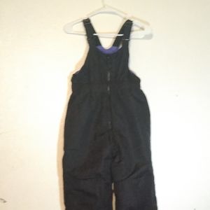 A kids black and purple polyester snow bib size medium